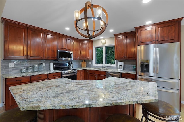 877 Red Fox Dr, Innsbrook, MO 63390 - kitchen featuring stainless steel appliances, a kitchen bar, backsplash, light stone counters, and recessed lighting
