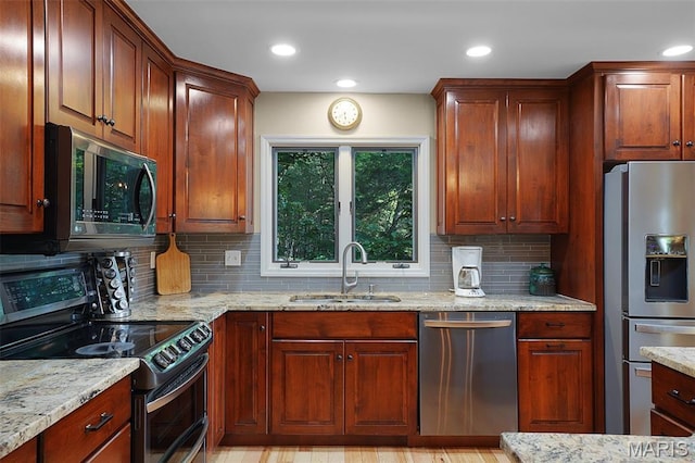 877 Red Fox Dr, Innsbrook, MO 63390 - kitchen featuring appliances with stainless steel finishes, tasteful backsplash, light stone counters, and recessed lighting
