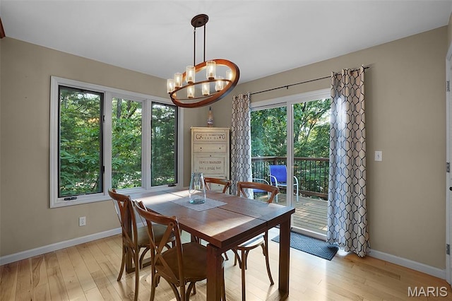 877 Red Fox Dr, Innsbrook, MO 63390 - dining area with light wood-type flooring, plenty of natural light, and a chandelier