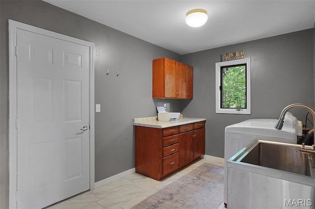 877 Red Fox Dr, Innsbrook, MO 63390 - washroom featuring cabinet space, washing machine and dryer, and light marble finish flooring