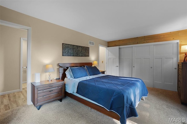 877 Red Fox Dr, Innsbrook, MO 63390 - bedroom with a closet, light colored carpet, and wooden walls