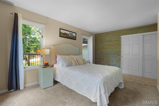 877 Red Fox Dr, Innsbrook, MO 63390 - bedroom featuring wooden walls, light colored carpet, and an accent wall