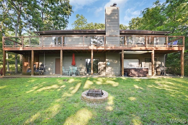 877 Red Fox Dr, Innsbrook, MO 63390 - rear view of property with a wooden deck, a fire pit, a chimney, and a yard