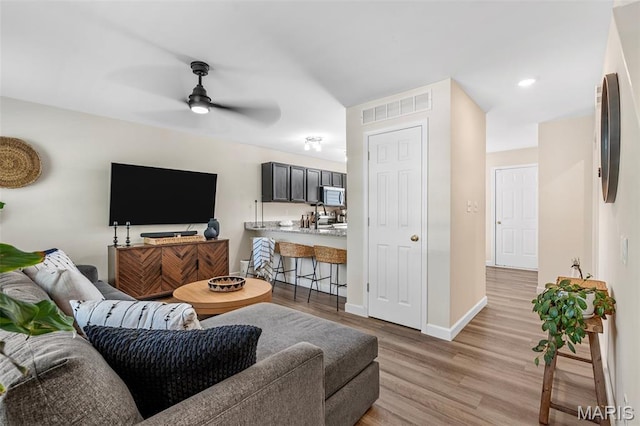 847 Boardwalk Springs Pl, Ofallon, MO 63368 - living area with a ceiling fan and light wood-type flooring