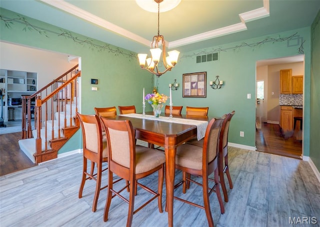 824 Legends View Dr, Eureka, MO 63025 - dining room with a chandelier, light wood-type flooring, and stairway