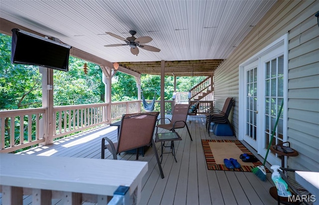 824 Legends View Dr, Eureka, MO 63025 - wooden deck featuring outdoor dining area, french doors, ceiling fan, and stairway