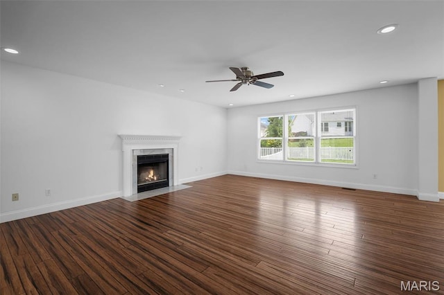 8 Dugout Ct, Ofallon, MO 63366 - unfurnished living room featuring a high end fireplace, wood finished floors, recessed lighting, and ceiling fan