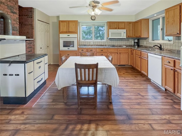 4423 Project Rd, Luebbering, MO 63061 - kitchen with white appliances, dark wood-type flooring, ceiling fan, decorative backsplash, and dark countertops