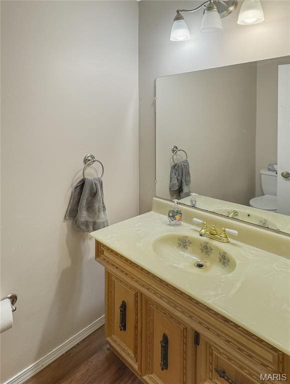 4423 Project Rd, Luebbering, MO 63061 - bathroom with toilet, vanity, wood finished floors, and baseboards