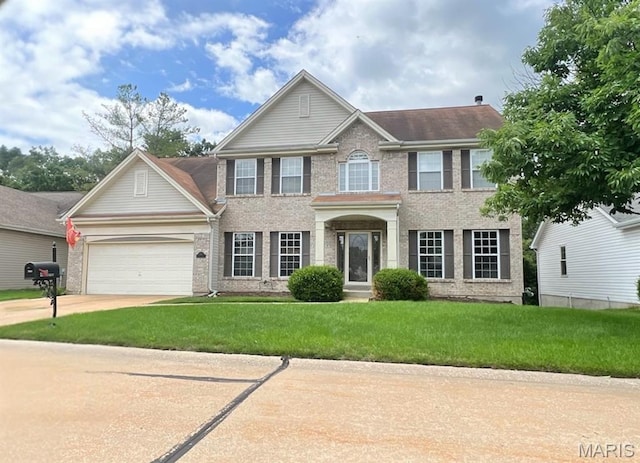 2860 Westridge Oaks Ct, Wildwood, MO 63040 - colonial house featuring brick siding, driveway, an attached garage, and a front yard