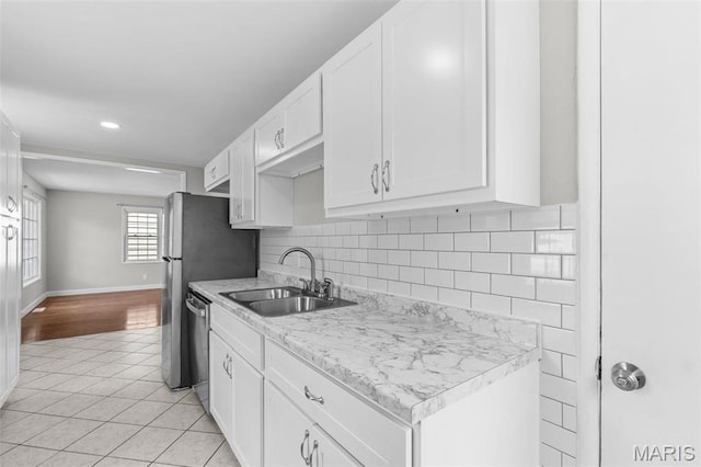 2490 Mullanphy Ln, Florissant, MO 63031 - kitchen featuring dishwasher, light tile patterned flooring, white cabinetry, recessed lighting, and tasteful backsplash