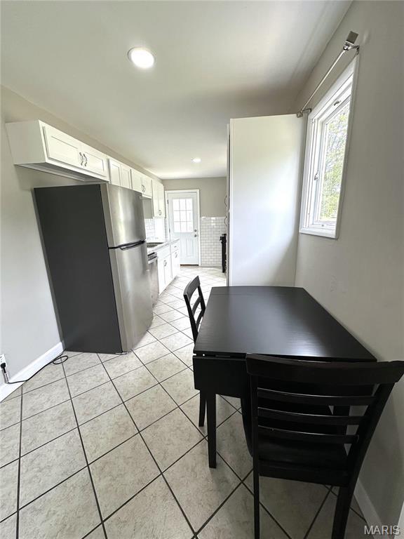 2490 Mullanphy Ln, Florissant, MO 63031 - dining area with light tile patterned floors and recessed lighting