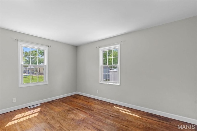 2490 Mullanphy Ln, Florissant, MO 63031 - spare room with plenty of natural light and wood finished floors