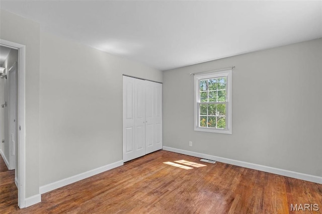 2490 Mullanphy Ln, Florissant, MO 63031 - unfurnished bedroom with wood finished floors and a closet