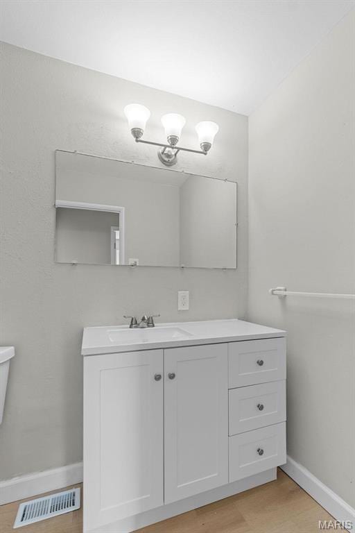 2490 Mullanphy Ln, Florissant, MO 63031 - bathroom featuring vanity and wood finished floors