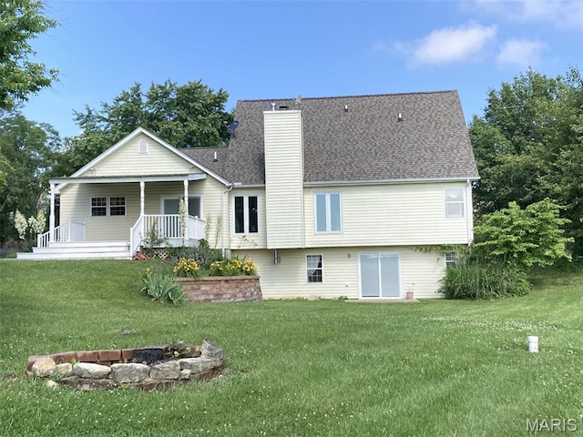 225 Country Crest Ln, Union, MO 63084 - back of property featuring a lawn, a chimney, an outdoor fire pit, a porch, and roof with shingles