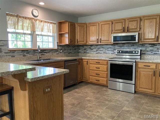 225 Country Crest Ln, Union, MO 63084 - kitchen featuring stainless steel appliances, tasteful backsplash, light stone countertops, a peninsula, and recessed lighting