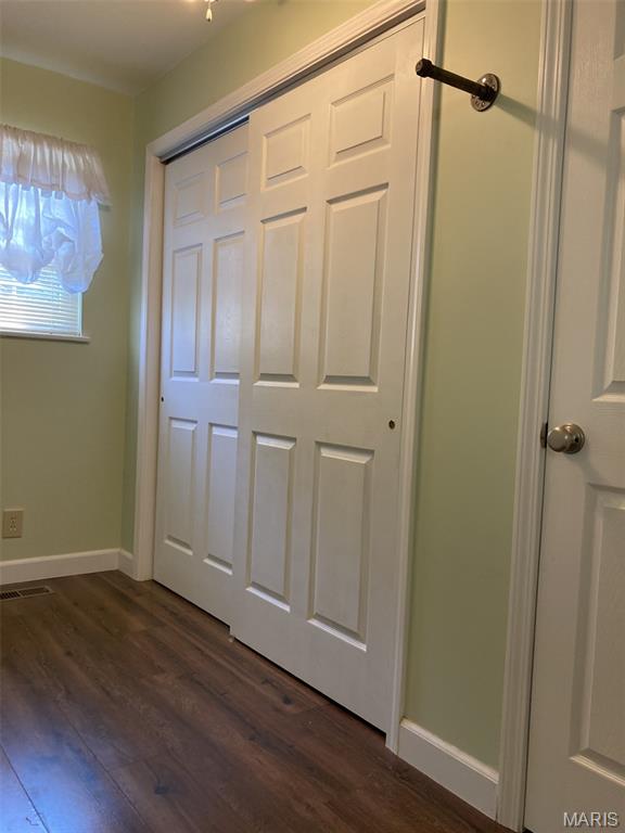 225 Country Crest Ln, Union, MO 63084 - unfurnished bedroom with dark wood-type flooring and a closet