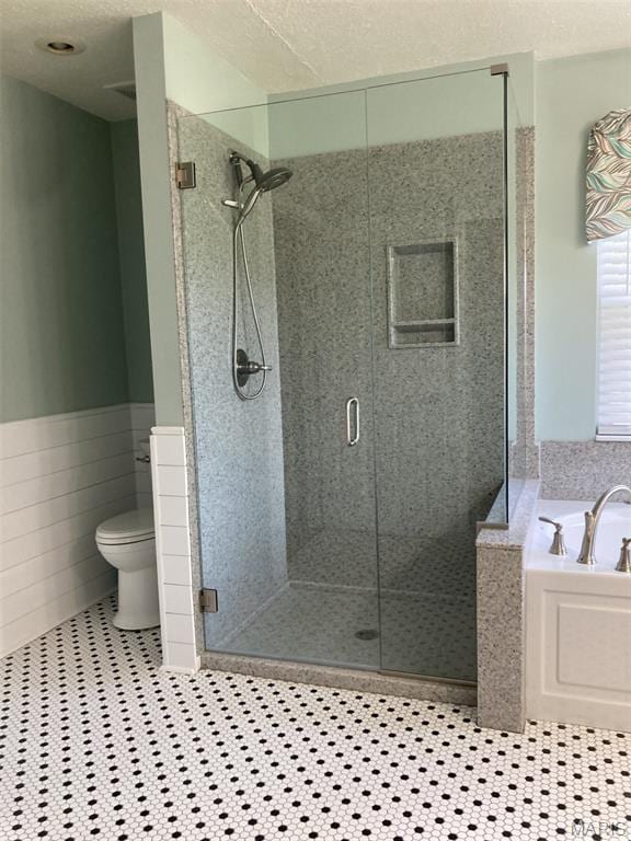 225 Country Crest Ln, Union, MO 63084 - full bathroom with a bath, a shower stall, and a wainscoted wall