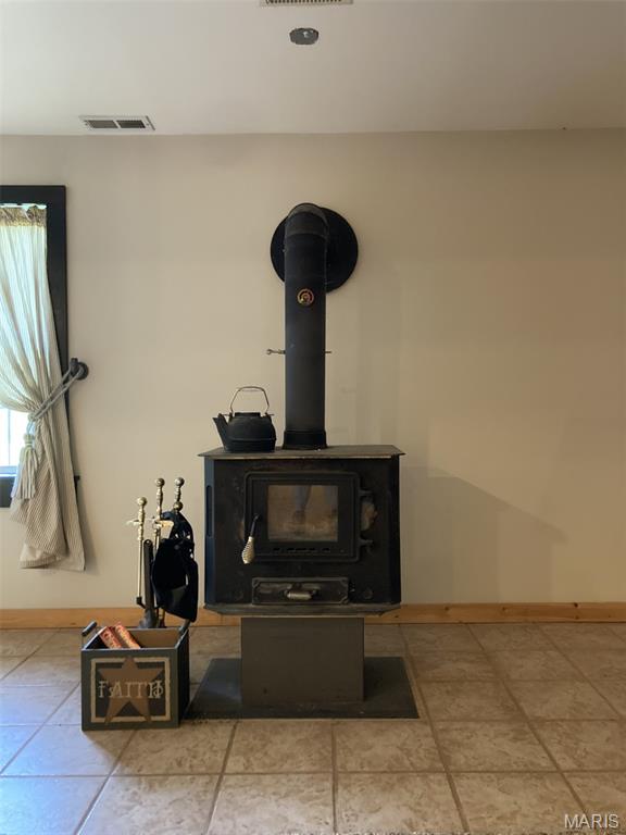 225 Country Crest Ln, Union, MO 63084 - detailed view of a wood stove and baseboards