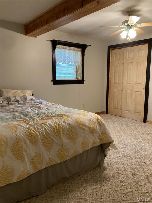 225 Country Crest Ln, Union, MO 63084 - carpeted bedroom with beam ceiling, ceiling fan, and a closet
