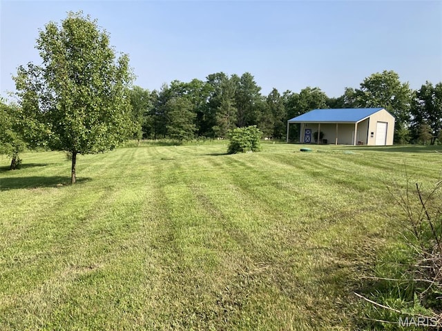 225 Country Crest Ln, Union, MO 63084 - view of green lawn featuring a garage, a pole building, and an outdoor structure