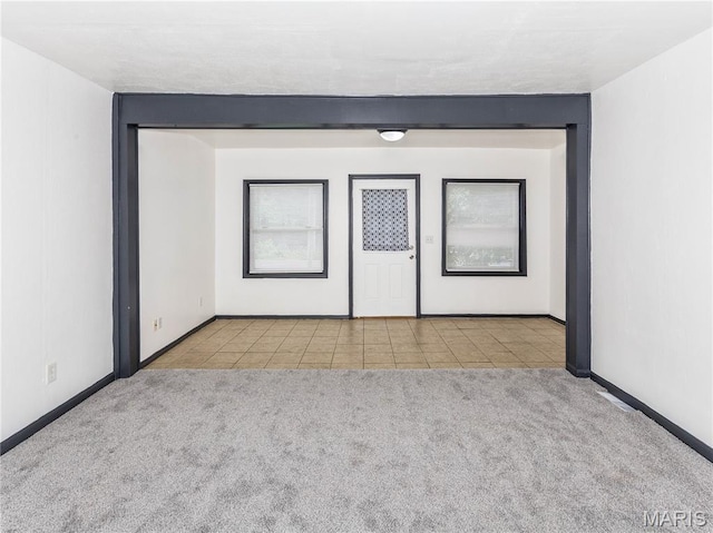 530 Poplar St, Highland, IL 62249 - tiled spare room featuring carpet floors and baseboards