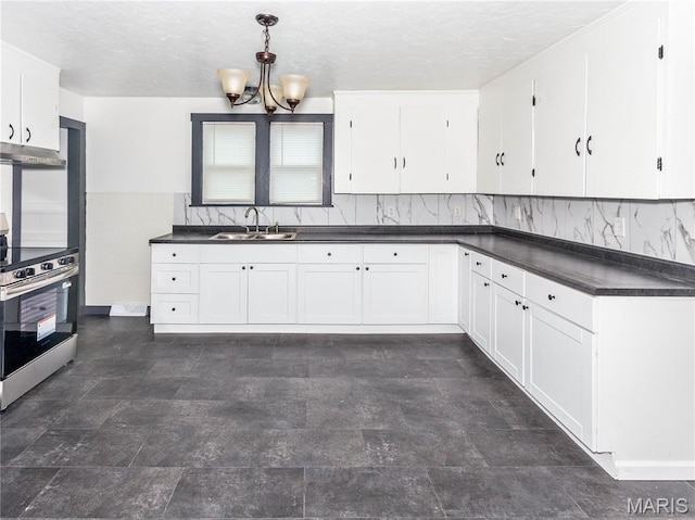 530 Poplar St, Highland, IL 62249 - kitchen featuring electric stove, dark countertops, a chandelier, white cabinets, and a textured ceiling