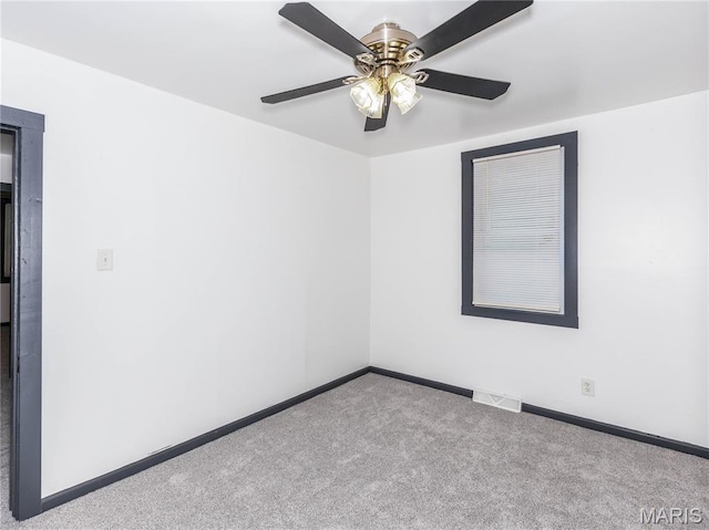 530 Poplar St, Highland, IL 62249 - spare room with carpet floors and a ceiling fan