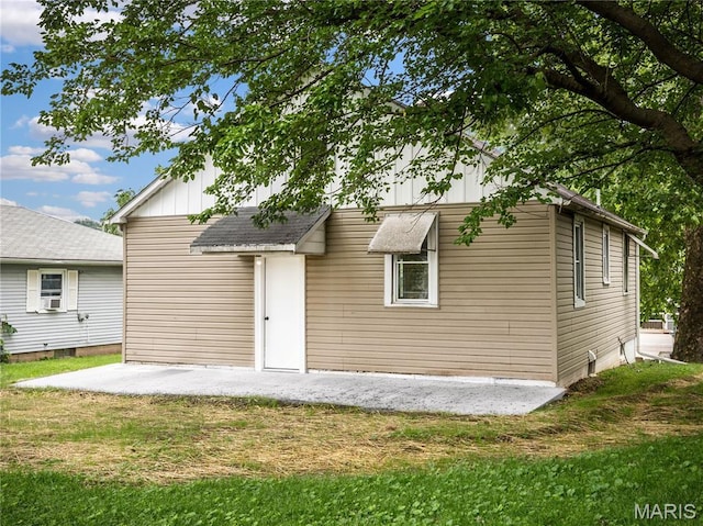 530 Poplar St, Highland, IL 62249 - rear view of house featuring a yard, a patio, board and batten siding, and cooling unit