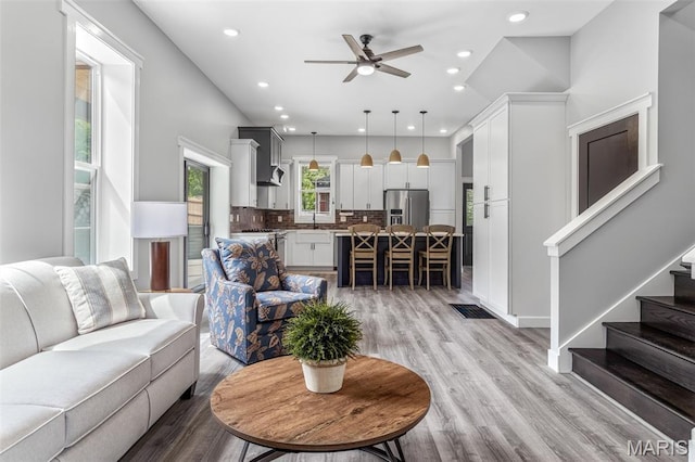 422 N 2nd St, De Soto, MO 63020 - living room with ceiling fan, light wood-style flooring, recessed lighting, and stairs