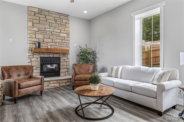 422 N 2nd St, De Soto, MO 63020 - living room with wood finished floors, a stone fireplace, and recessed lighting
