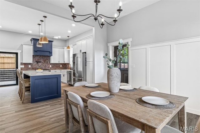 422 N 2nd St, De Soto, MO 63020 - dining area with light wood-type flooring, a chandelier, and recessed lighting