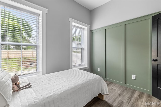422 N 2nd St, De Soto, MO 63020 - bedroom with multiple windows and light wood-style flooring