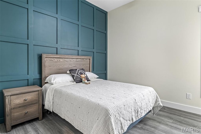 422 N 2nd St, De Soto, MO 63020 - bedroom featuring wood finished floors and a decorative wall