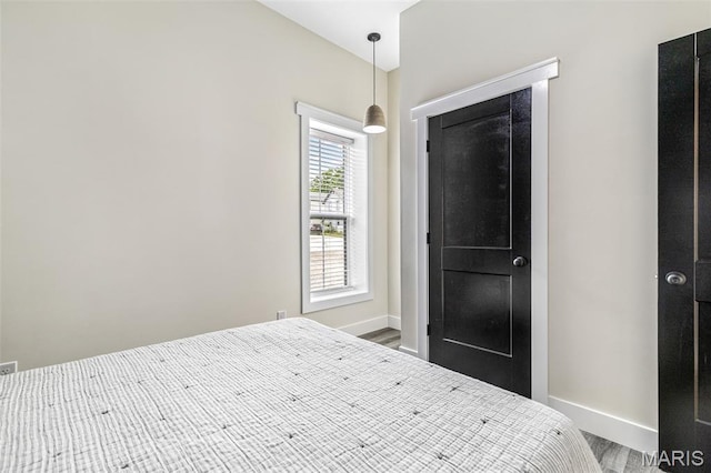 422 N 2nd St, De Soto, MO 63020 - bedroom with wood finished floors and baseboards