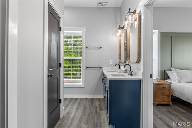 422 N 2nd St, De Soto, MO 63020 - full bathroom with double vanity, wood finished floors, and ensuite bath