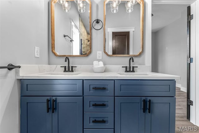 422 N 2nd St, De Soto, MO 63020 - bathroom featuring double vanity and wood finished floors