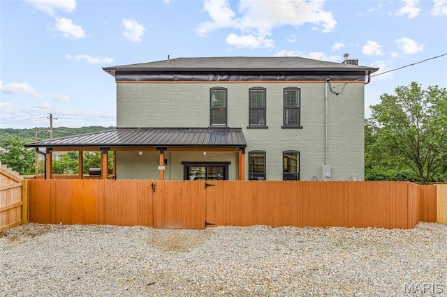 422 N 2nd St, De Soto, MO 63020 - rear view of house with a standing seam roof, a metal roof, and brick siding