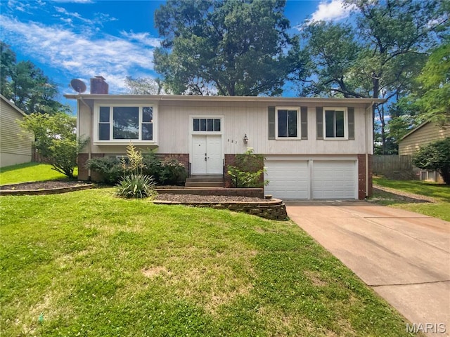 887 Totem Woods Ct, Manchester, MO 63021 - raised ranch with brick siding, a garage, concrete driveway, a front lawn, and a chimney
