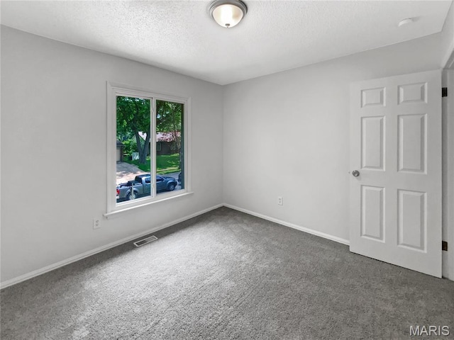 887 Totem Woods Ct, Manchester, MO 63021 - carpeted spare room with a textured ceiling and baseboards