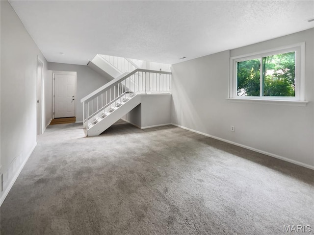 887 Totem Woods Ct, Manchester, MO 63021 - unfurnished living room featuring stairway, carpet flooring, and a textured ceiling
