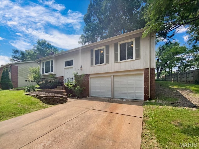 887 Totem Woods Ct, Manchester, MO 63021 - raised ranch featuring brick siding, an attached garage, and concrete driveway