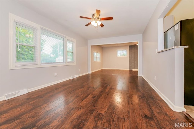 3702 E 106th Ter, Kansas City, MO 64137 - unfurnished living room featuring ceiling fan and wood finished floors