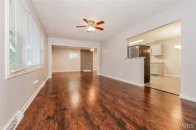 3702 E 106th Ter, Kansas City, MO 64137 - unfurnished living room with a ceiling fan, hardwood / wood-style floors, and a chandelier