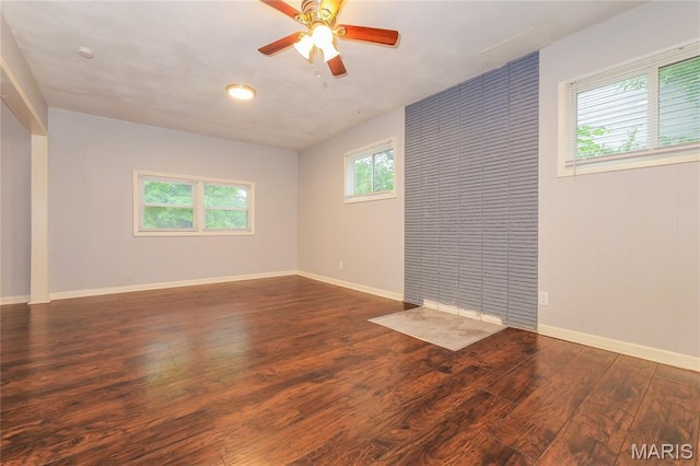 3702 E 106th Ter, Kansas City, MO 64137 - empty room featuring wood finished floors, ceiling fan, and a smoke detector
