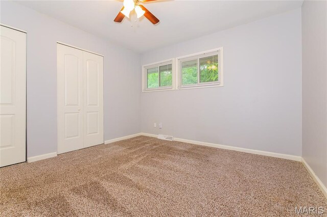 3702 E 106th Ter, Kansas City, MO 64137 - unfurnished bedroom featuring carpet floors, a closet, and a ceiling fan