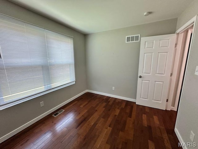 69 Jakes Ct, Ofallon, MO 63366 - unfurnished bedroom with dark wood-style flooring and baseboards