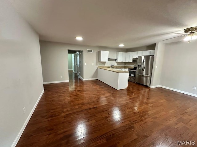 69 Jakes Ct, Ofallon, MO 63366 - kitchen with stainless steel appliances, a peninsula, white cabinetry, dark wood finished floors, and recessed lighting