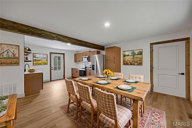 10293 Strange Rd, Potosi, MO 63664 - dining space featuring light wood-style flooring, beam ceiling, and recessed lighting